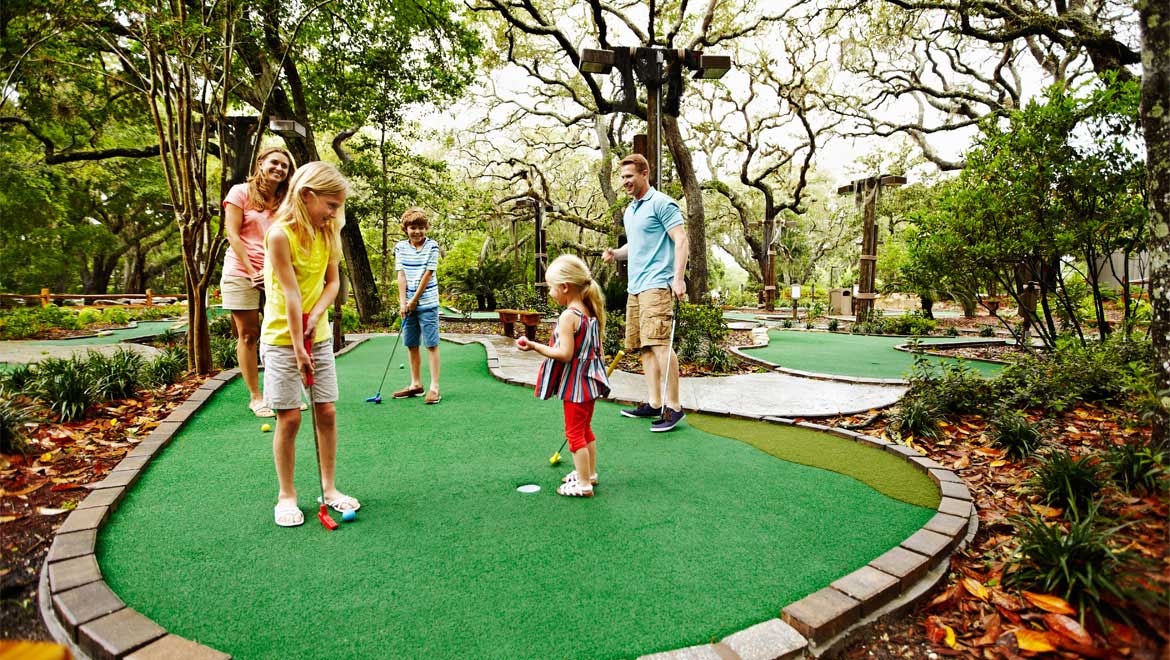 Family playing miniature golf at Amelia Island